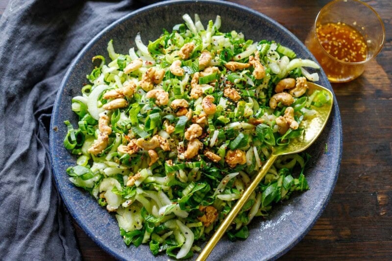 This refreshing bok choy salad is tossed in a sweet and tangy sesame ginger dressing, topped with crunchy sesame cashew brittle. Vegan and gluten-free.