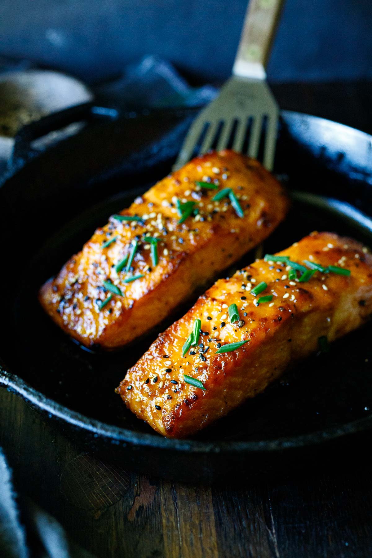 broiled salmon in a skillet with miso, chives and sesame seeds. 