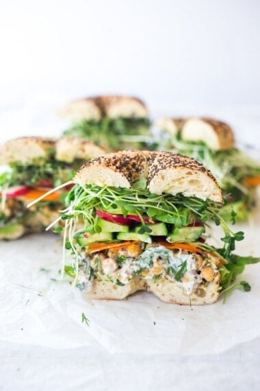 This vegan Chickpea Salad Sandwich is incredibly delcious! It's made with a herby smashed chickpea salad and layered with avocado, cucumbers, tomatoes, and microgreens. Gluten-free adaptable! Video. 