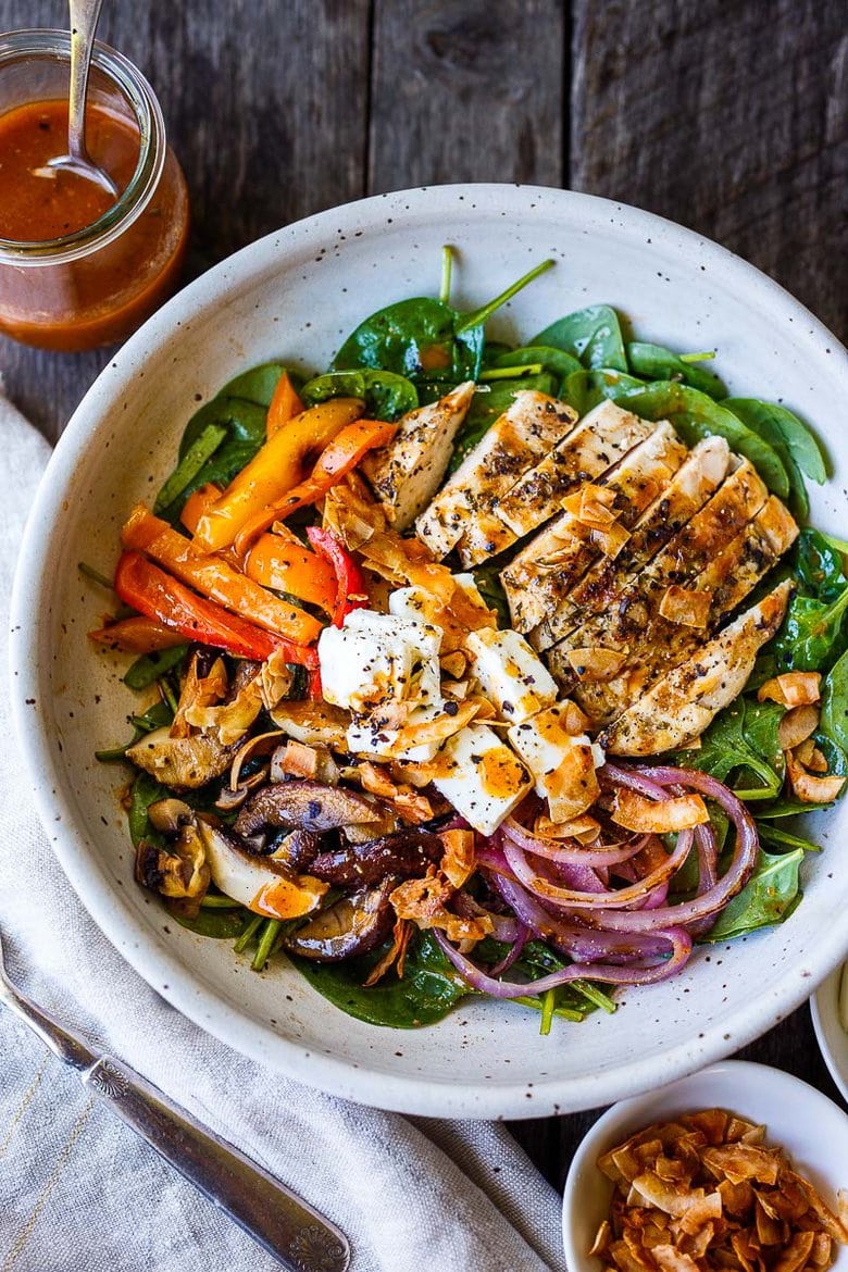 spinach salad with grilled mushrooms, red onions, peppers, and grilled chicken topped with coconut bacon, feta, and French dressing.