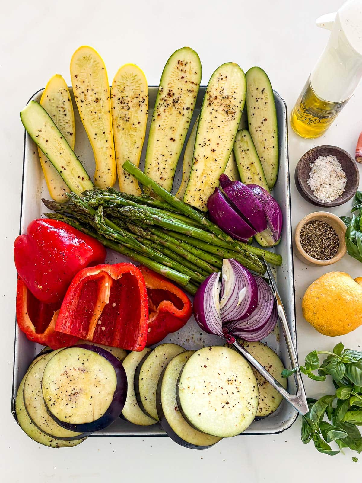 Expertly prepped vegetables, ready for grilling on a sheet pan. 