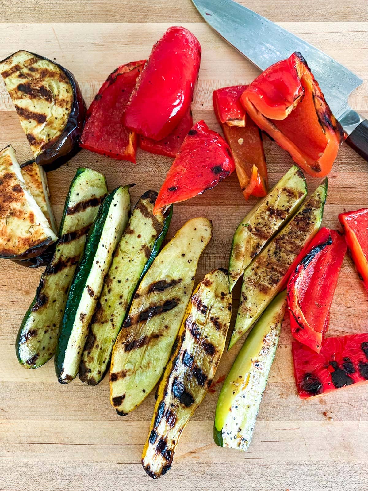 Cutting the grilled veggies after then are grilled. 