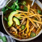 This Chicken Tortilla Soup is one of BEST recipes on the blog and hands-down one of our favorite dinners. Delicious and healthy, loaded with chicken and veggies, this soup will warm you to your bones! Make it in an Instant pot, on the stovetop, or in a slow cooker!